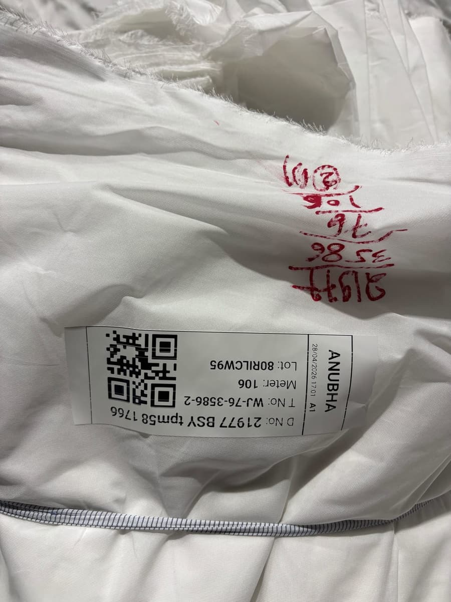 MobiOffice-generated barcode label on a finished taka at Anubha Fabrics