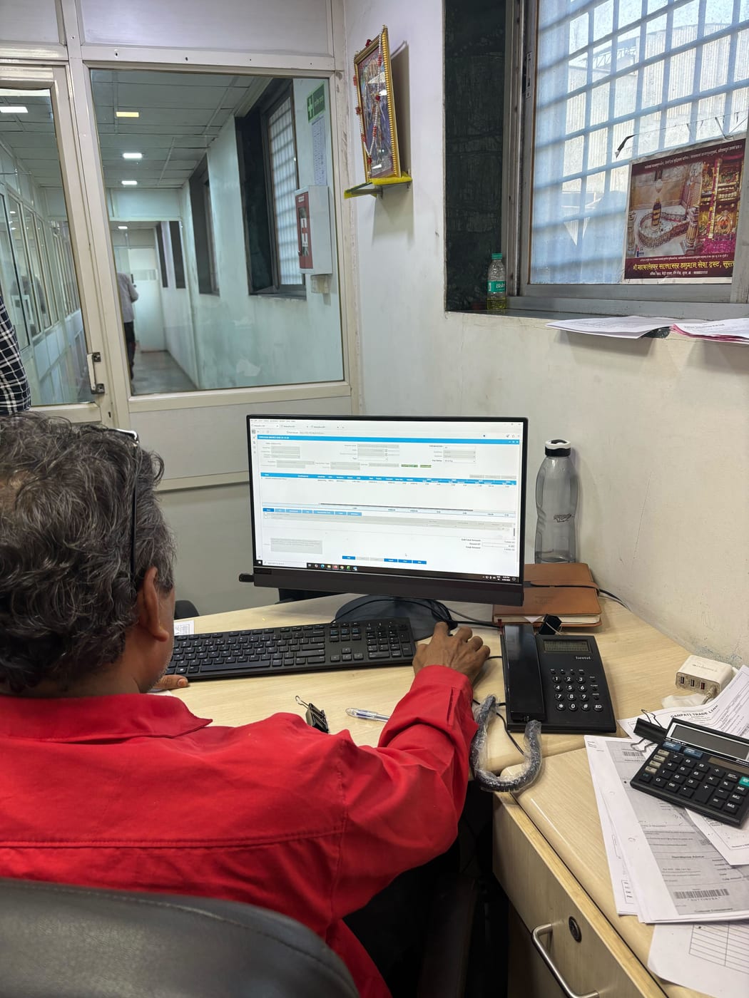 Kottex Industries staff member reviewing MobiOffice reports at their desk