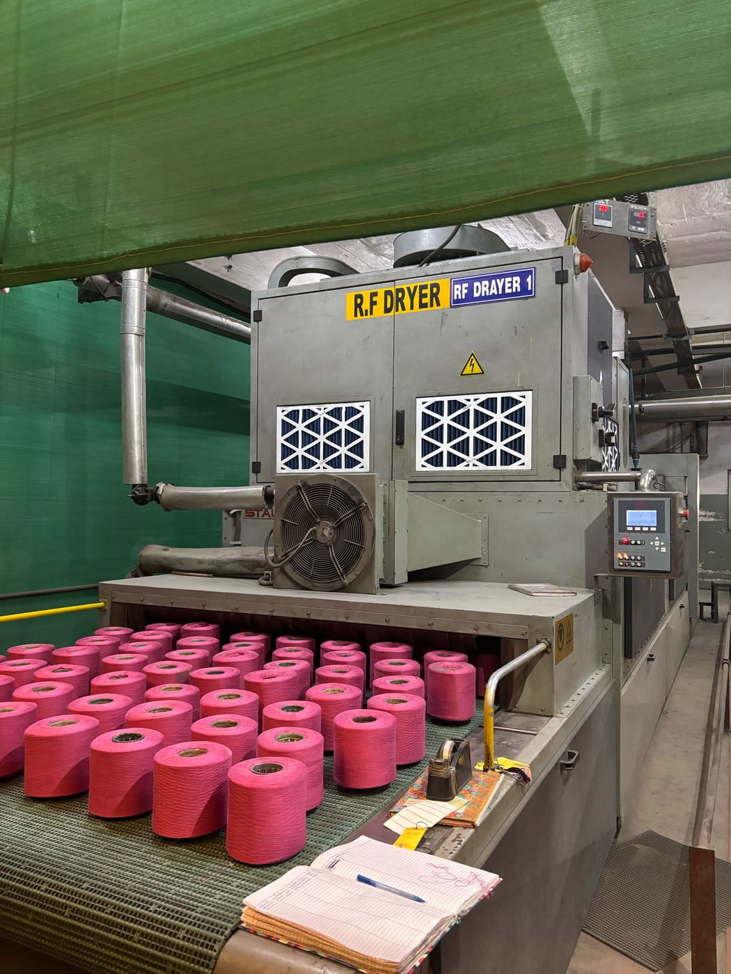 Dyed yarn cones coming out of the RF Dryer 1 at Kottex Industries yarn dyeing unit